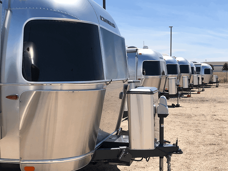 Follow Your Dream: An Essential Guide to RVing for Beginners - Airstreams on a dealer lot in Idaho